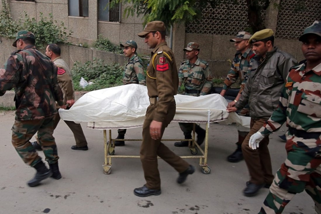 Indian army soldiers carry the body of a colleague who was killed in an attack on an army camp, on a stretcher outside a hospital in Jammu on Sunday. Photo: Reuters