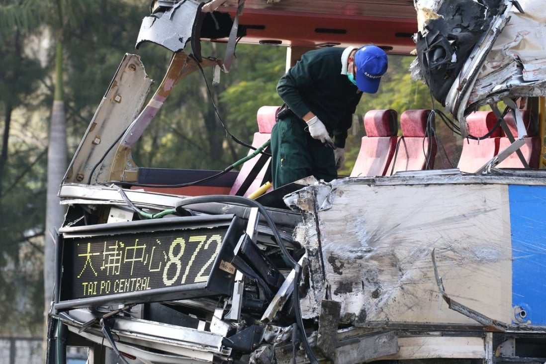 Officers from the Transport Department on Monday inspect the bus involved in the crash. Photo: David Wong