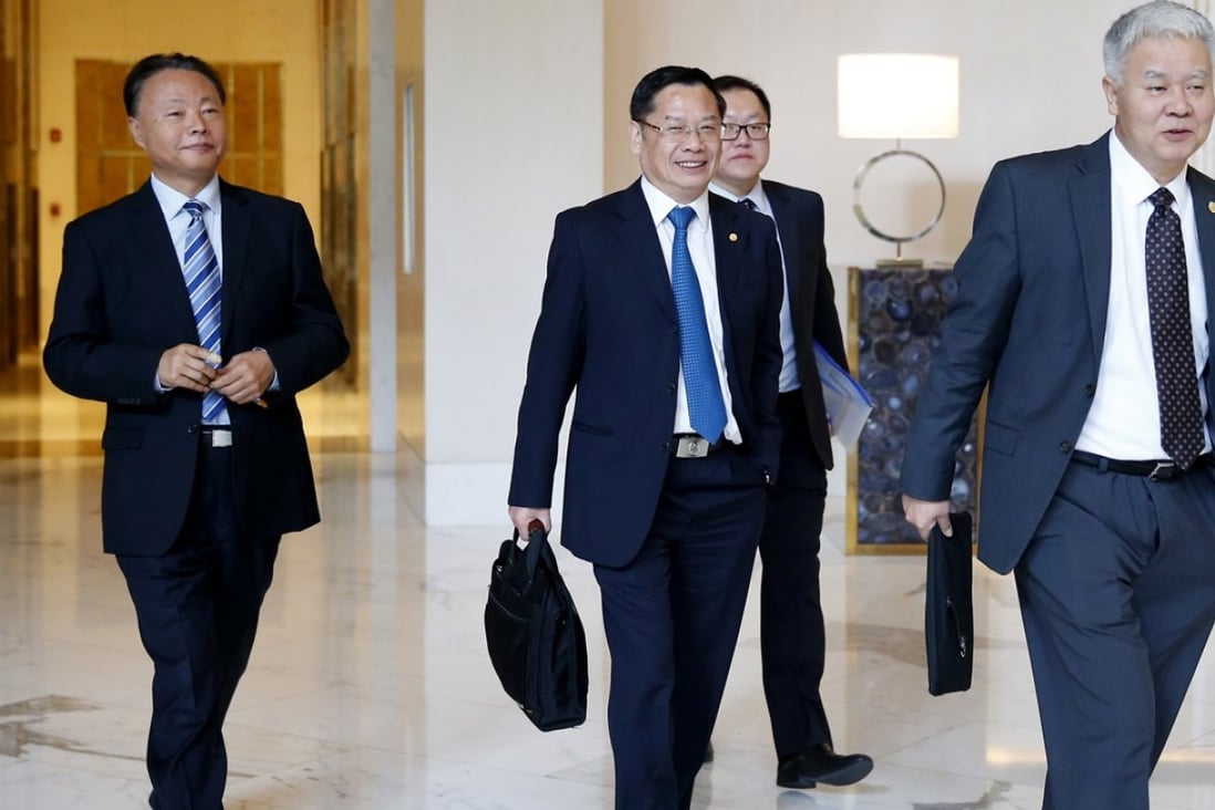 China’s ambassador to the Philippines, Zhao Jianhua (left), and other Chinese foreign ministry officials head for talks in Manila. Photo: AP