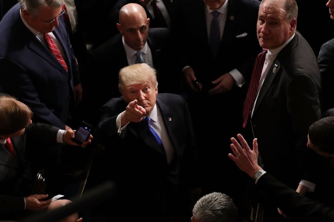 US President Donald Trump points to guests calling his name from the galleries following the State of the Union address on January 30 in Washington. Trump’s chaotic first year might be a sign that calm is on the way. Photo: Getty Images