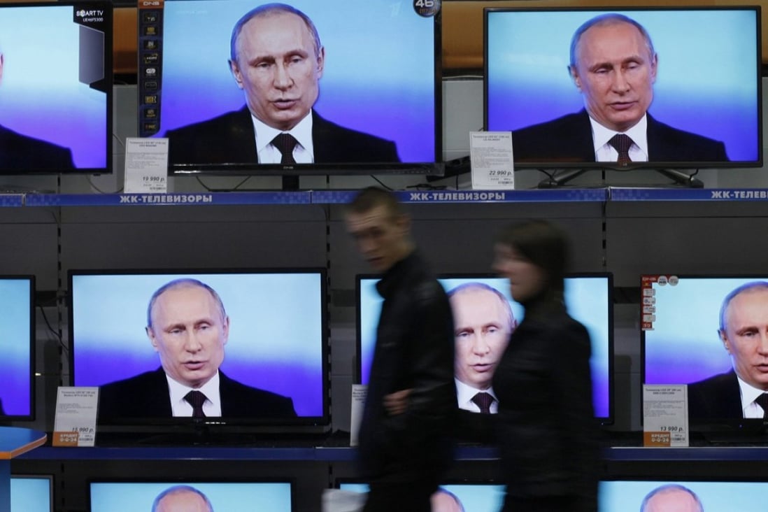 Visitors walk past TV sets showing a speech by Russian President Vladimir Putin. Another Russian institution, SKOLKOVO, as the the Moscow School of Management is known, is the most recognisable MBA brand in Russia.Photo: Reuters