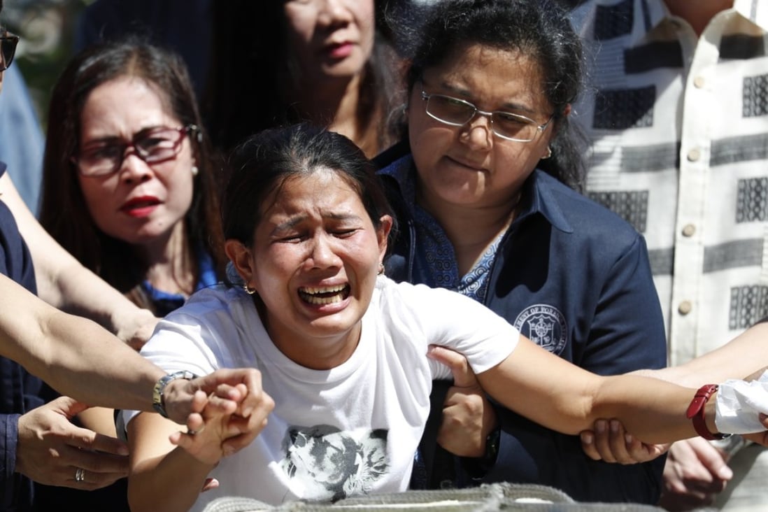 Jessica Demafelis grieves on the return of her sisters', Joanna Demafelis, remains at Manila's international airport, Philippines. Photo: EPA