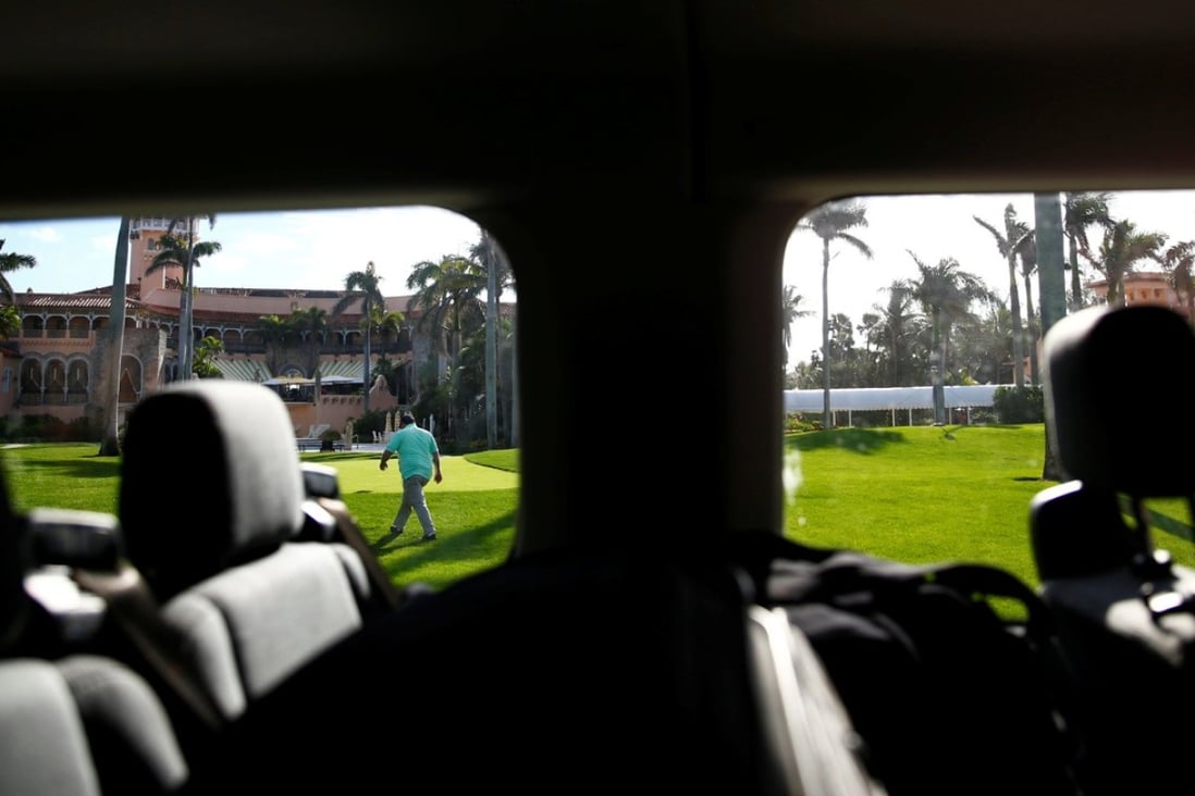 A United States Secret Service agent is seen from a press van at US President Donald Trump's Mar-a-Lago estate in Palm Beach, Florida, on Sunday. On Monday, a driver in Trump’s Mar-a-Lago motorcade was detained after he was found to be in possession of a gun. Photo: Reuters