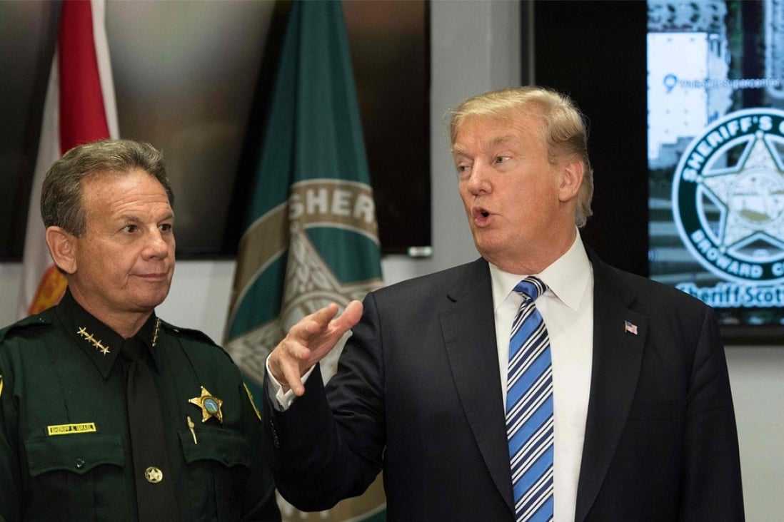US President Donald Trump (seen with Broward County Sheriff Scott Israel on February 12) has signalled support for a bipartisan effort to improve background checks for gun purchases in the wake of the Florida school shooting. Photo: AFP