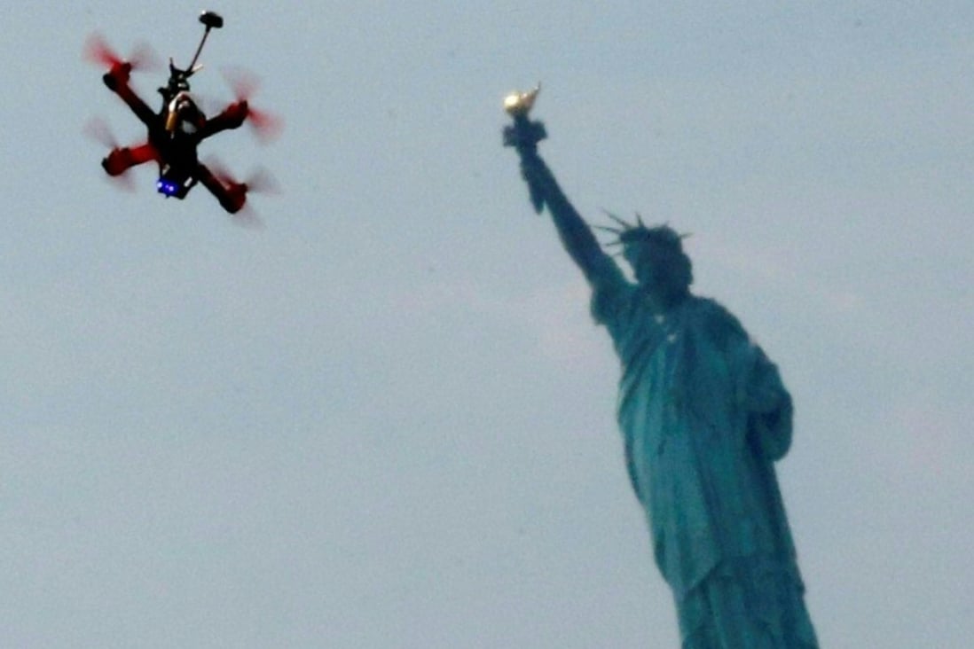 Quadcopter drones fly over the Statue of Liberty during the practice event before the National Drone Racing Championship at Governors Island in New York. Photo: AFP/KENA BETANCUR