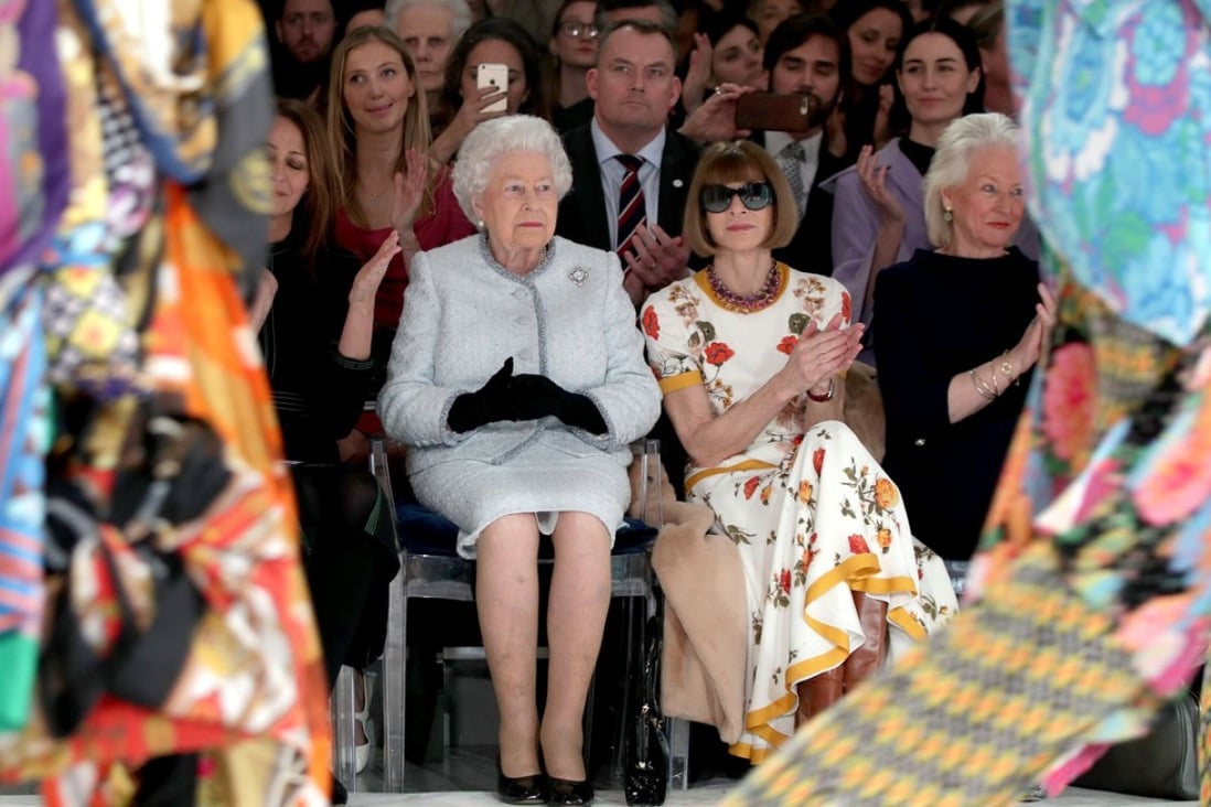 Britain's Queen Elizabeth II sits next to ‘Vogue’ Editor-in-Chief Anna Wintour (second from right), Caroline Rush (left), chief executive of the British Fashion Council, and royal dressmaker Angela Kelly (far right) as they view Richard Quinn's runway show before presenting him with the inaugural Queen Elizabeth II Award for British Design during London Fashion Week on Tuesday. Photo: Pool via Reuters