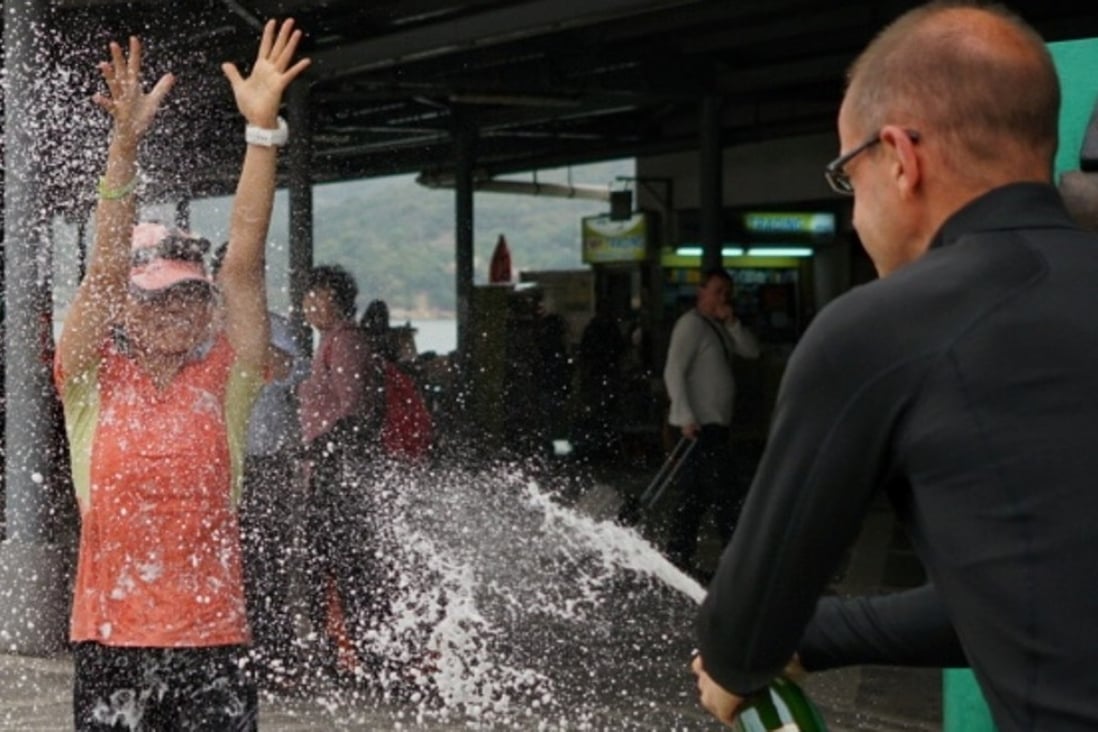 Lu Ming-chu celebrates running 298km with champagne. Photos: Lloyd Belcher