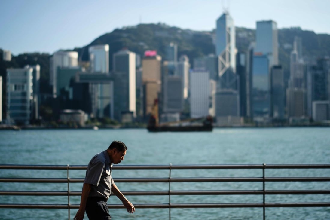 An elderly man walks on a Kowloon promenade. David Dodwell argues outmoded ideas about retirement and older workers are frustrating efforts to tackle future challenges and our government is barely acknowledging the problem. Photo: AFP