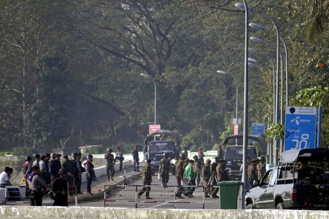 Soldiers and police block the road near the site of a bomb explosion in Sittwe, Rakhine State. Photo: EPA