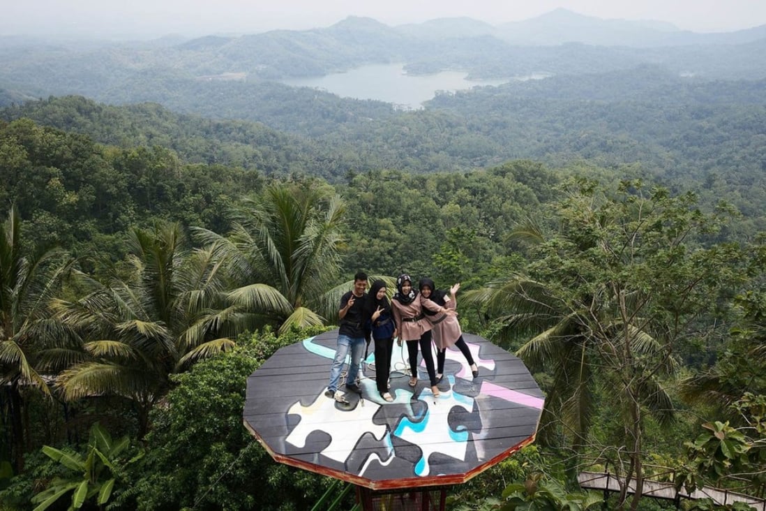 Visitors pose on a platform at the Pulepayung tourist attraction in Kulon Progo regency, special region of Yogyakarta, Indonesia. Photo: Bloomberg