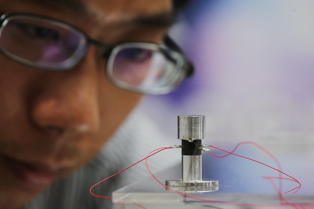 Ping Guo, Assistant Professor at the Chinese University of Hong Kong’s Department of Mechanical and Automation Engineering, demonstrating a prototype of a self-levitating device at CUHK on 9 October 2017. Photo: SCMP / Dickson Lee
