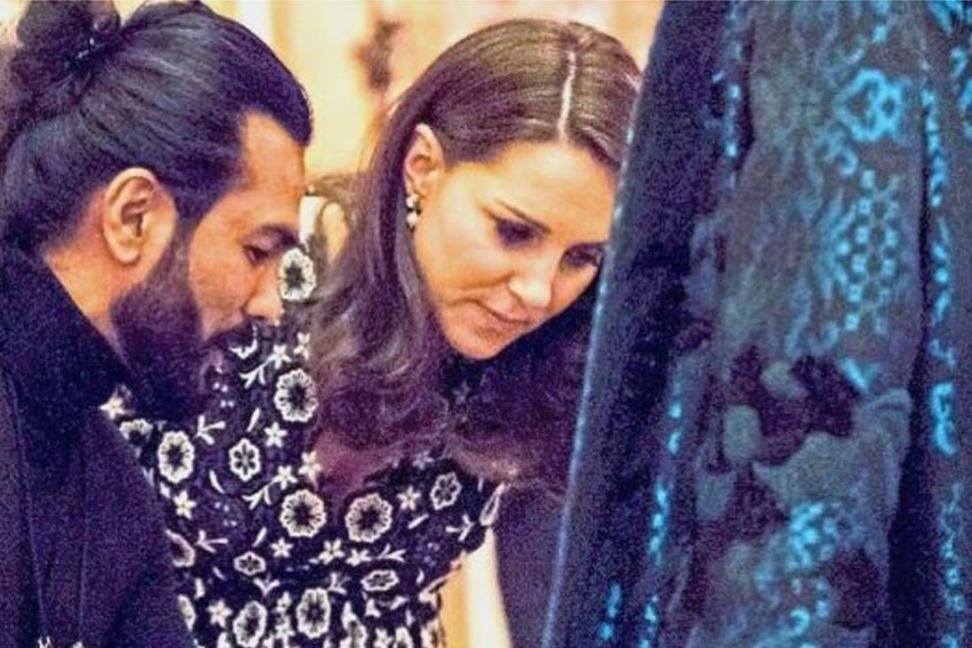 Bernard Chandran presents one of his designs to Catherine, the Duchess of Cambridge, at Buckingham Palace. Photo: The Star