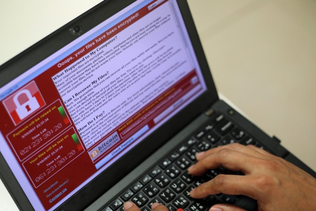 A programmer shows a sample of a ransomware cyberattack on a laptop. Photo: EPA/RITCHIE B. TONGO