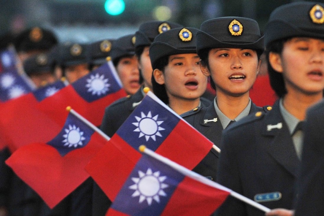 Military school students attend a flag-raising ceremony in Taipei. The self-ruled island is expected to come under greater unification pressure if Xi Jinping stays on as Chinese president past 2023. Photo: AFP