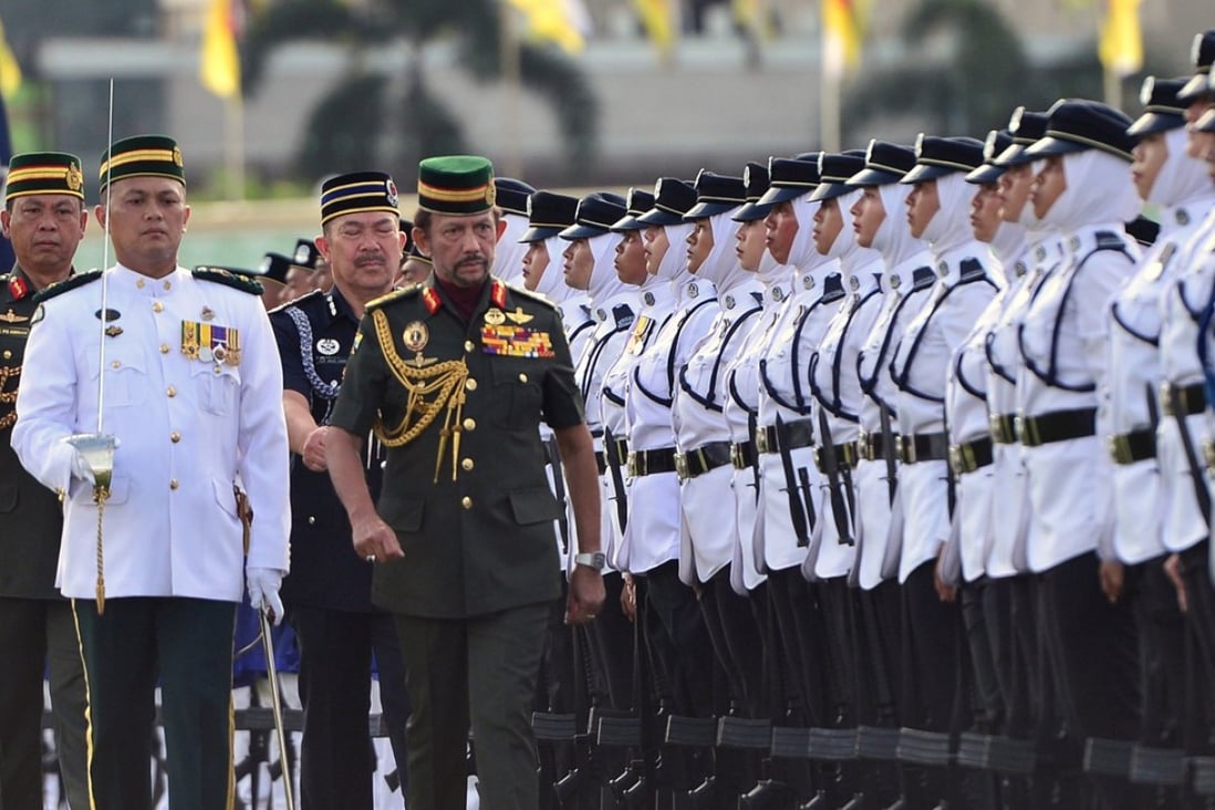 The Sultan of Brunei, Hassanal Bolkiah, inspects an honour guard during National Day celebrations last month. Photo: Reuters