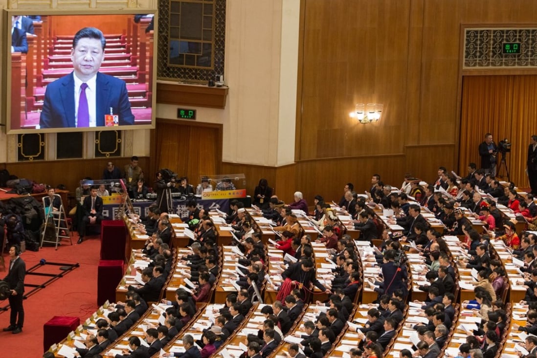 Xi Jinping is seen on a screen as delegates attend the opening session of the National People’s Congress on Monday. Photo: EPA-EFE
