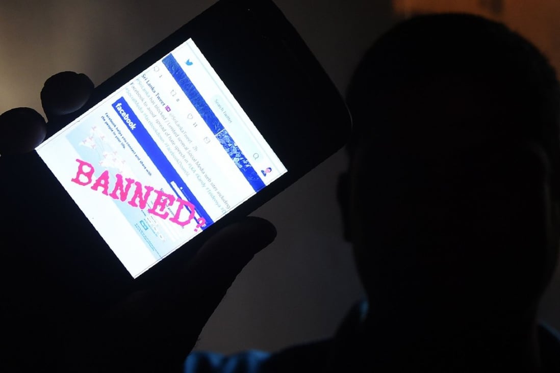A Sri Lankan man holds up his mobile phone showing a ‘Banned’ message on Facebook. The government has blocked access to major social media sites in an effort to stamp out race fuelled violence. Photo: AFP