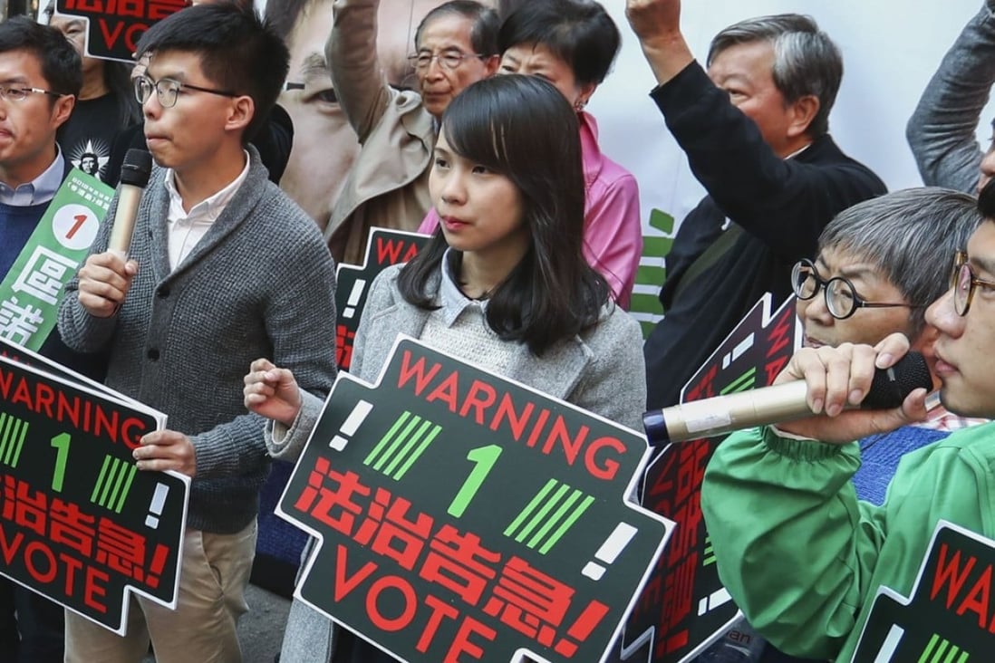 Joshua Wong Chi-fung (second from left), Agnes Chow (third from left), Nathan Law (extreme right) and Au Nok-hin (left) drumming up support for Au on polling day. Photo: Nora Tam