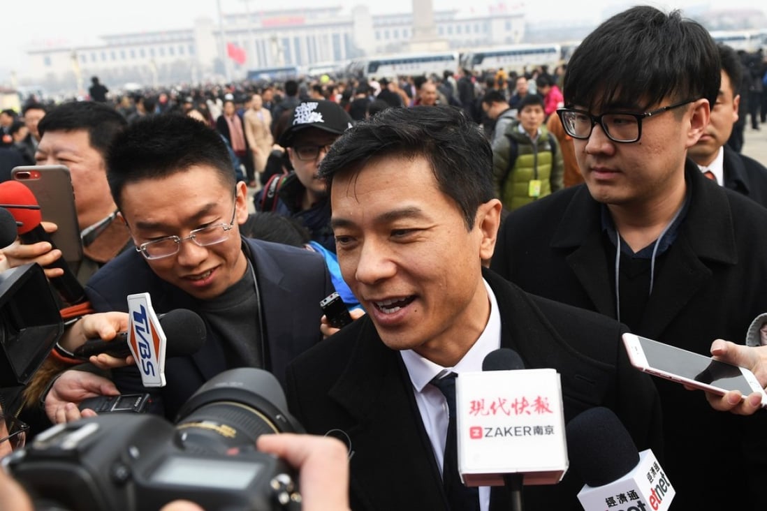 Baidu CEO Robin Li speaks to media as he arrives for the opening session of the Chinese People's Political Consultative Conference in Beijing on March 3, 2018. Photo: AFP