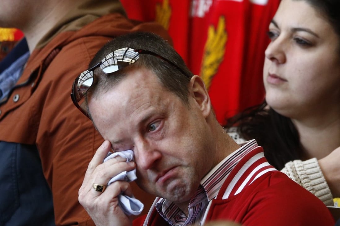A man weeps during a memorial service to mark the 25th anniversary of the Hillsborough disaster at Anfield. Photo: Reuters