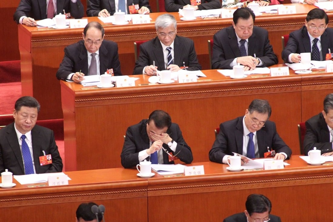 President Xi Jinping (left) and Premier Li Keqiang listen as Li Jianguo, vice-chairman of the National People’s Congress, delivers a report on the draft supervision law on Tuesday. Photo: Simon Song