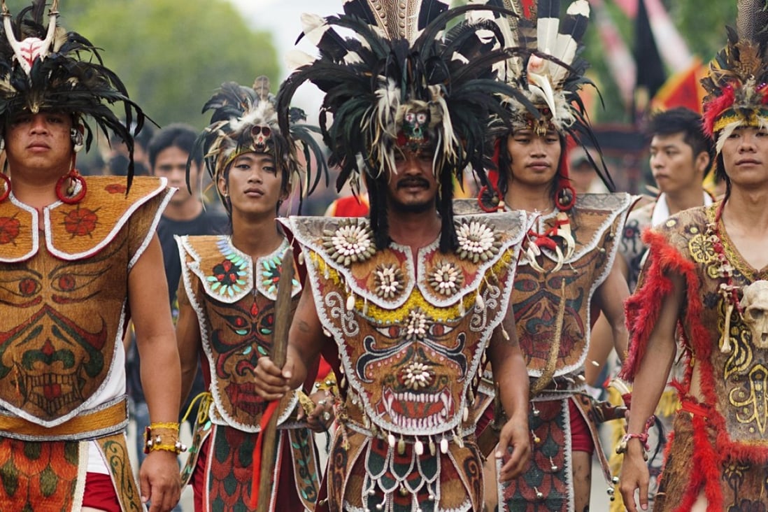 Borneo’s Dayak people wearing traditional dress. The Last Wild Men of Borneo explains that the Dayak often bullied the shy and placid Penan, another of the island’s indigenous groups. Photo: Shutterstock