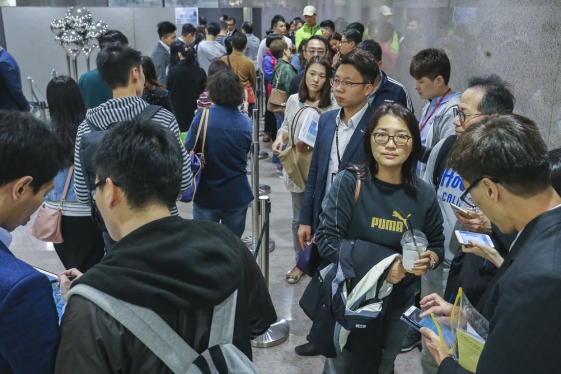 Potential buyers queuing up to bid for Wheelock’s Malibu apartments at Lohas Park in Tseung Kwan O on March 17, 2018. As many as 15 buyers registered for every unit that was available for sale. Photo: SCMP / Dickson Lee
