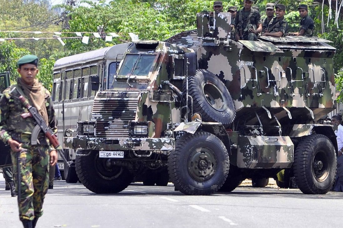 Sri Lankan police commandos patrol the streets of Pallekele, a suburb of Kandy. File photo: AFP