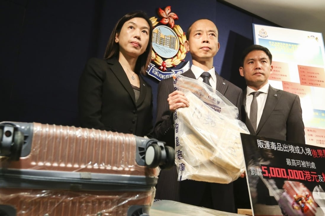 Officials from the Security Bureau’s narcotics division display 20kg of cocaine seized from a courier at the Shenzhen Bay Control Point in July 2017. Picture: Dickson Lee