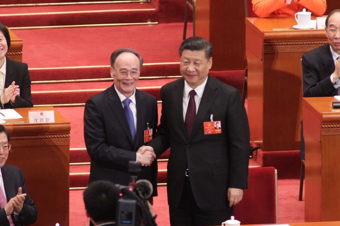 Wang Qishan (left) shakes hands with President Xi Jinping after being voted in as China’s new vice-president. Photo: Simon Song