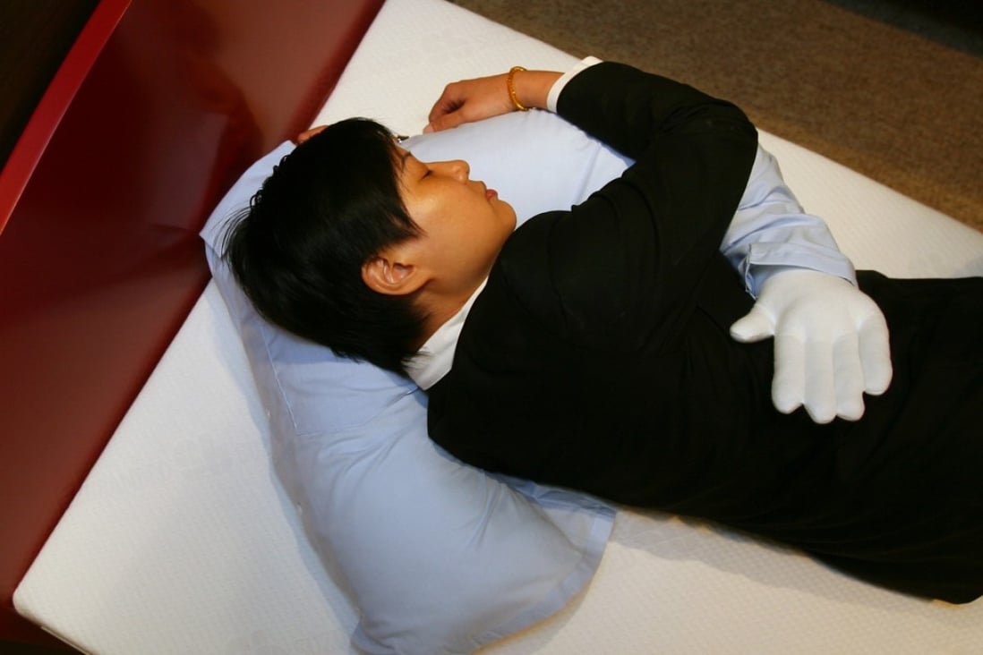 The so-called “boyfriend pillow”, targeted at lonely women, is demonstrated at a store in Causeway Bay, Hong Kong. Photo: SCMP
