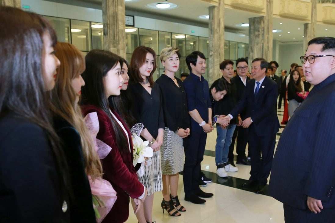 INorth Korean leader Kim Jong-un talks to members of the South Korean artistic group, including girl band Red Velvet (left-fourth left), after their performance in East Pyongyang Grand Theatre on Sunday. Photo: AP
