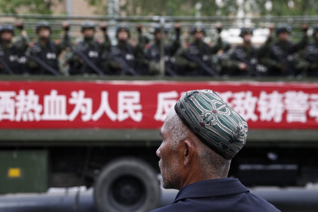 A Uygur man looks on as a truck carrying paramilitary police officers travels along a street in Urumqi, capital of China’s far western Xinjiang region in this file image. Photo: Reuters
