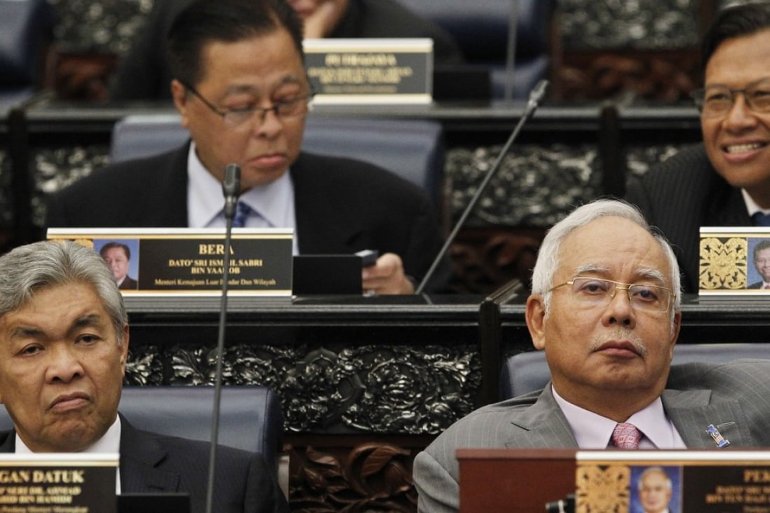 Malaysian Prime Minister Najib Razak, front right, sits next to his deputy, Ahmad Zahid Hamidi, at Parliament House in Kuala Lumpur on March 28. Critics say new voting maps, ratified on the day, will worsen inequality among the constituencies and etch them based on racial lines. Photo: AP