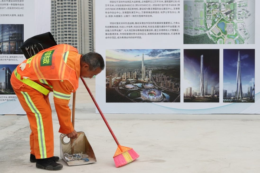 Shenzhen’s property market is under extreme upwards pressure amid surging population growth. A worker at the groundbreaking ceremony of Shimao Property’s Shenzhen-Hong Kong International Centre project in Longgang. Photo: K. Y. Cheng
