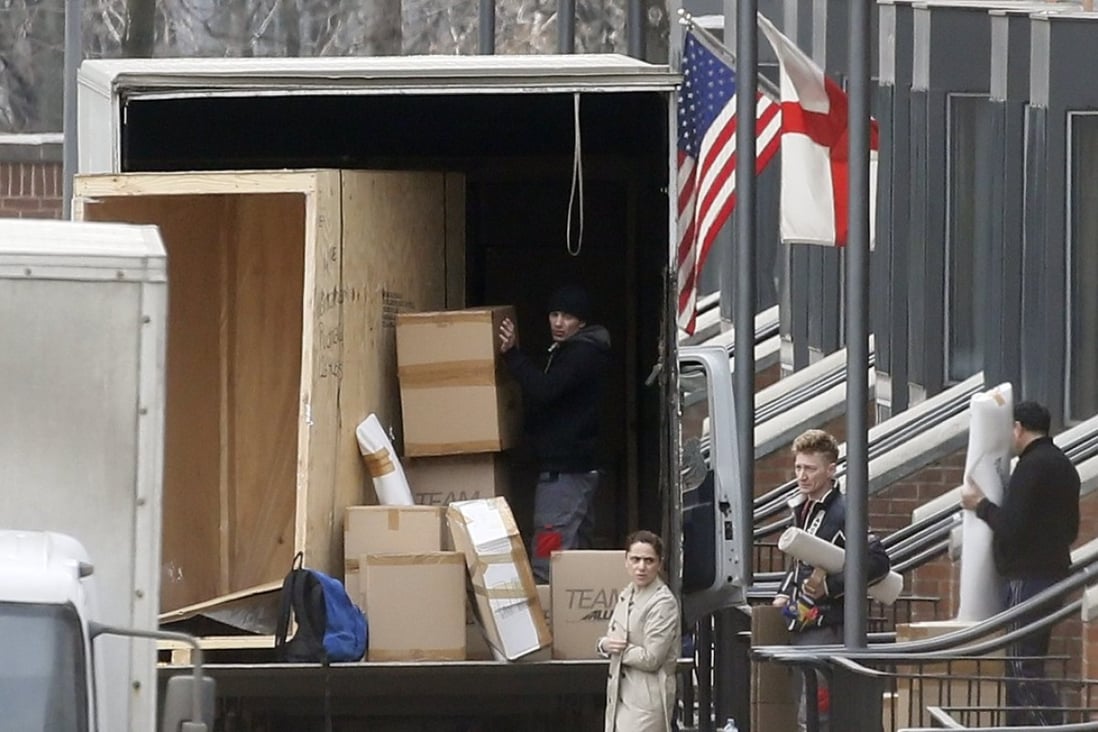 People carry boxes to a truck at the US embassy in Moscow. Photo: AFP