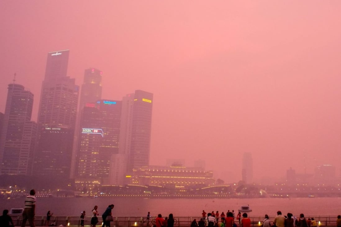 Haze enshrouds Singapore at dusk. Sharlene Teo’s novel Ponti evokes the notorious haze of 2003 in the city state. Photo: EPA