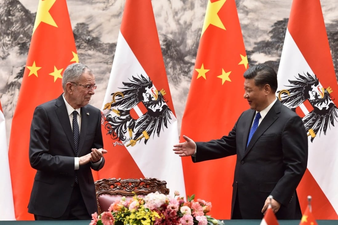 Chinese President Xi Jinping (right) extends a hand to Austrian President Alexander Van der Bellen during a signing ceremony in Beijing on Sunday. The two leaders agreed to establish a Sino-Austrian partnership to protect global trade. Photo: AFP