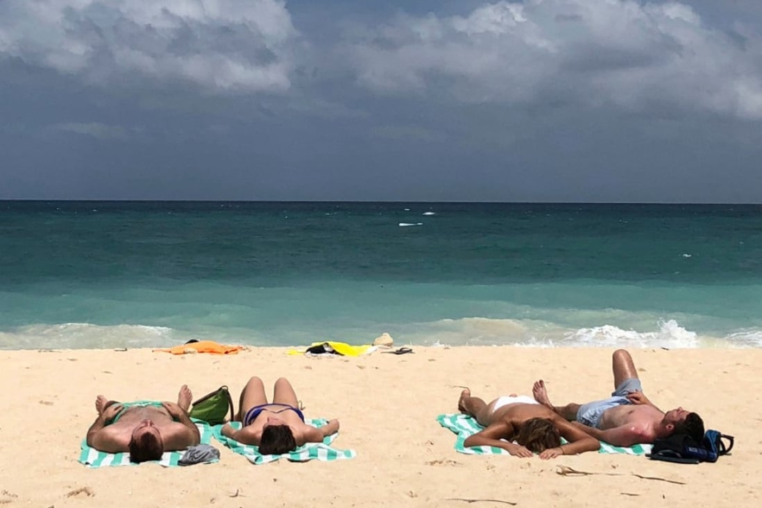 Tourists sunbathe on a beach on Boracay in the Philippines, in March 2018. Picture: AP