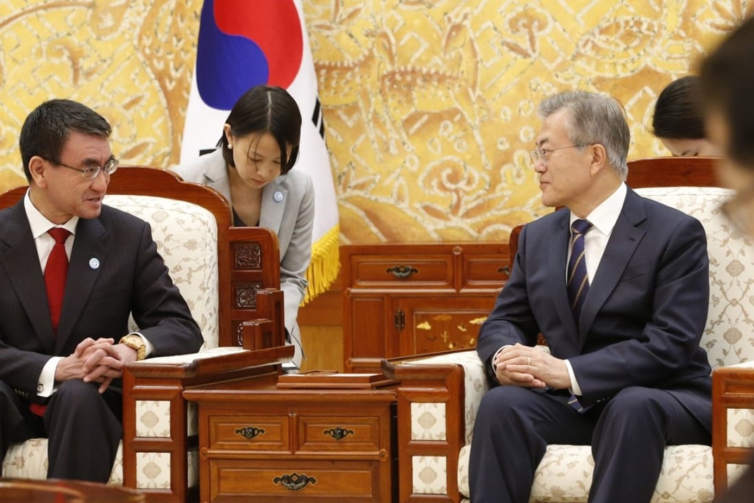 Japanese Foreign Minister Taro Kono talks with South Korean President Moon Jae-in. Photo: AP