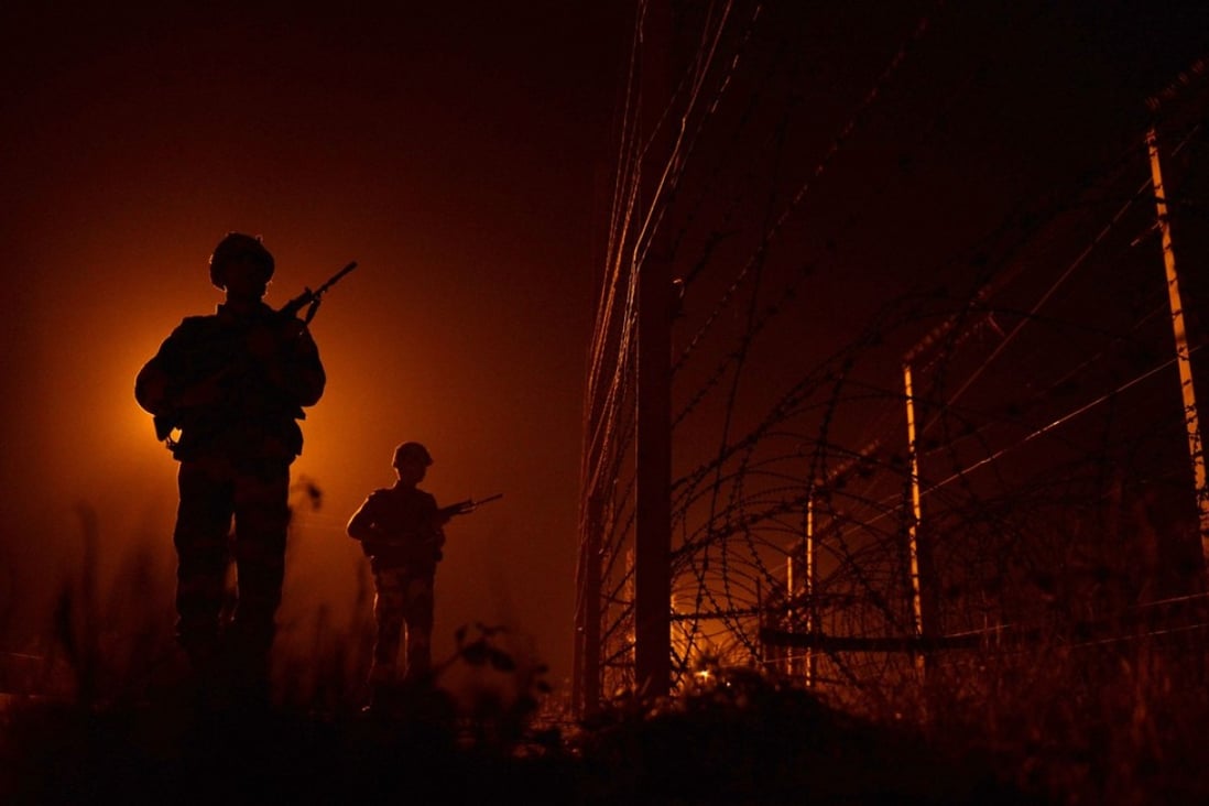 Indian Border Security Force soldiers patrol the fence-line along the India-Pakistan border some 36 kms southwest of Jammu. Cross-border clashes between nuclear-armed rivals India and Pakistan in Kashmir have reached the highest levels in 15 years. Photo: AFP