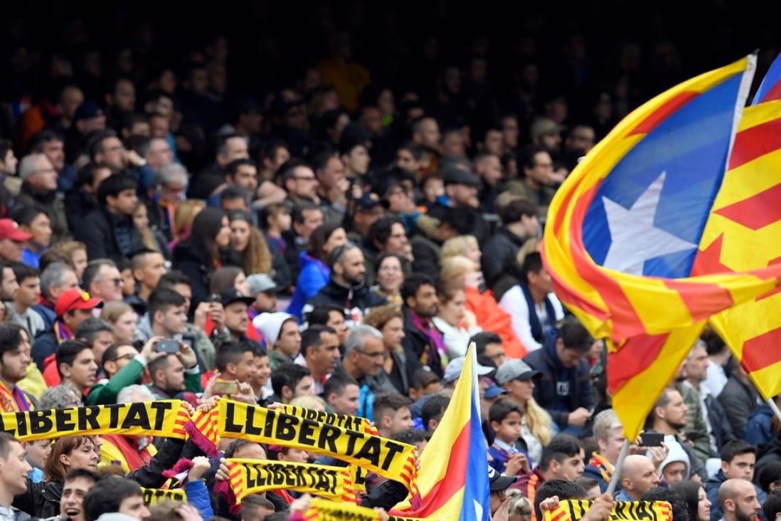 Barcelona fans hold up scarves demanding freedom during the match against Valencia CF at the Camp Nou. Photo: AFP