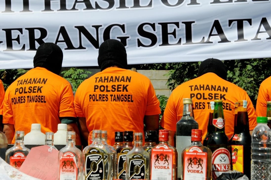 Suspects arrested for producing and selling illegal home-made alcohol are put on parade by Indonesian police during a public display in South Tangerang, outside Jakarta. Photo: AFP
