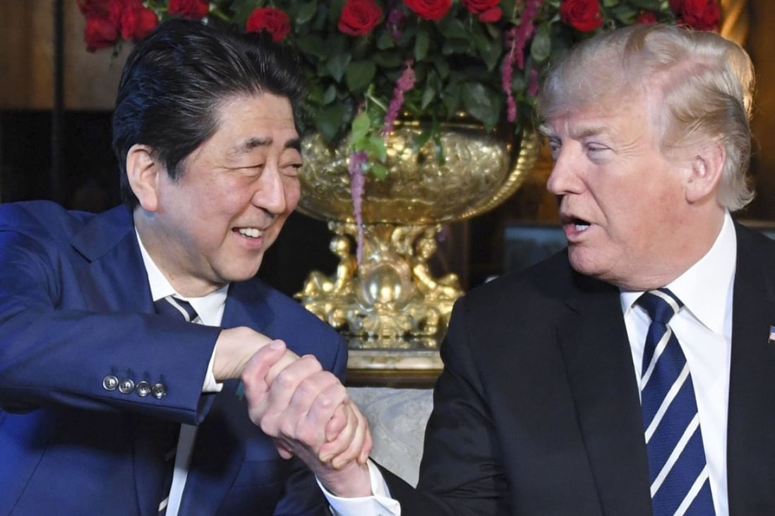 US President Donald Trump and Japanese Prime Minister Shinzo Abe shake hands during a meeting in Palm Beach, Florida. Photo: Kyodo