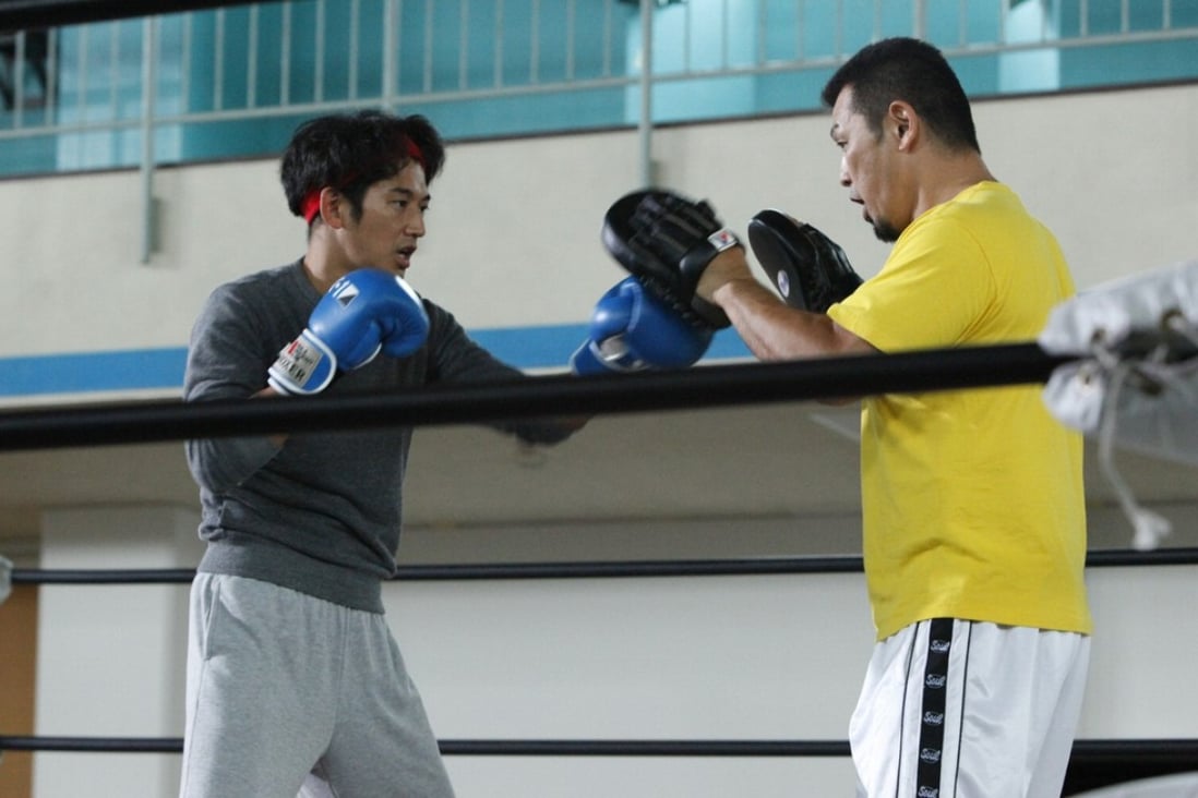 Eita (left) in a still from The Ringside Story (category IIA; Japanese), directed by Masaharu Take. It also stars Eriko Sato.