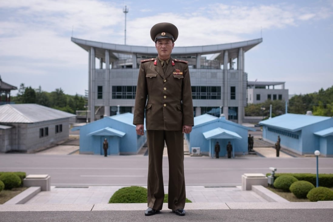 In a photo taken on June 2, 2017, North Korean soldier Lieutenant Kim poses for a portrait before the military demarcation line at the truce village of Panmunjom within the Demilitarized Zone (DMZ) separating North and South Korea. Photo: AFP