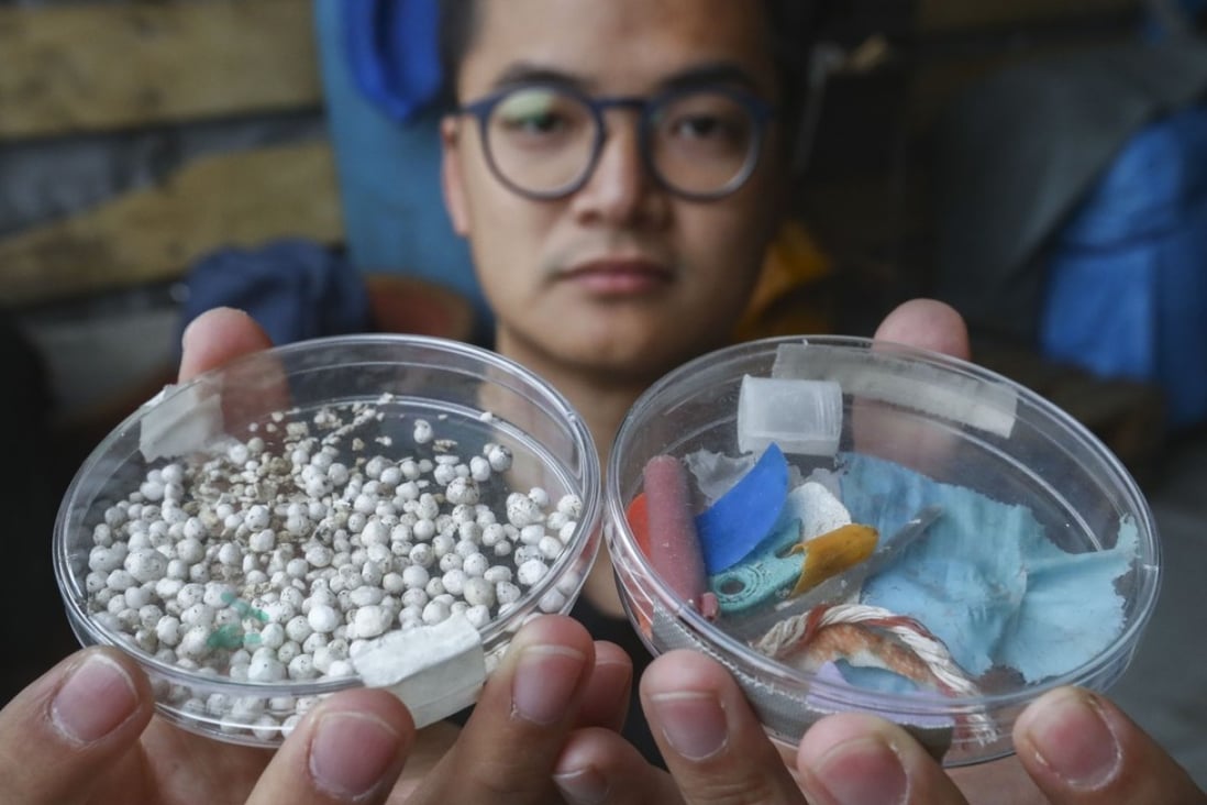 A Greenpeace campaigner displays samples of microplastics collected near Ping Chau in the Tolo Channel, on January 7. Photo: Nora Tam