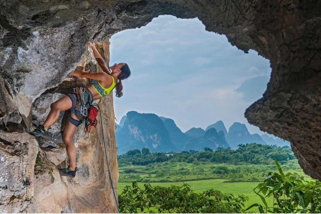 A female climber ascending the Egg, a well-known crag in Yangshuo, Guangxi province, China. Photo: Alamy
