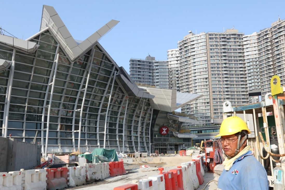 A construction worker toils near the West Kowloon Terminus for the Guangzhou-Shenzhen-Hong Kong Express Rail Link. Property agents expect real estate values to continue to trend higher in anticipation of the station opening in the third quarter. Photo: Felix Wong