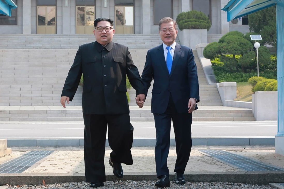 North Korean leader Kim Jong-un (left) and South Korean President Moon Jae-in walk to the Peace House building for talks in the truce village of Panmunjom on Friday. Photo: AFP / KCNA via KNS